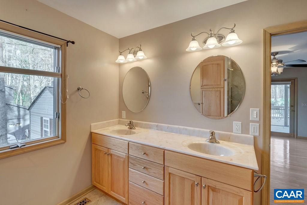 9 Out Of Bounds Road Palmyra, VA 22963 - Photo 21 of 37 a bathroom with a double vanity sink and a mirror