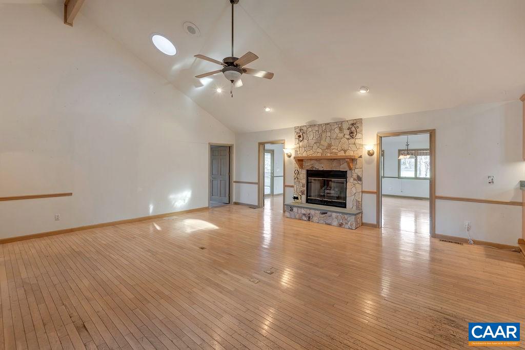 9 Out Of Bounds Road Palmyra, VA 22963 - Photo 3 of 37 a view of an empty room with wooden floor fireplace and a window