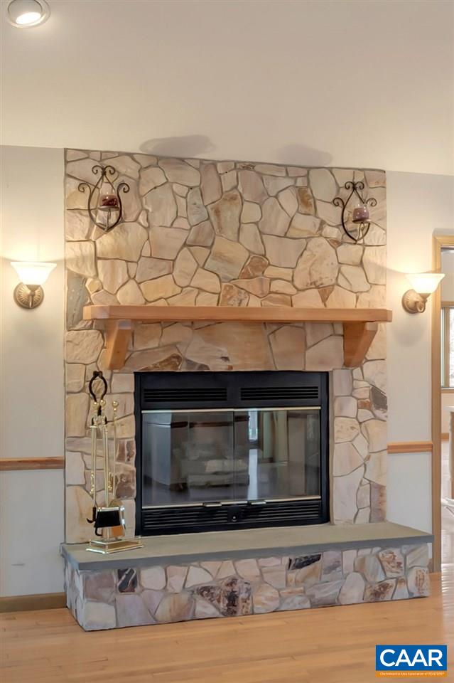 9 Out Of Bounds Road Palmyra, VA 22963 - Photo 5 of 37 a fireplace with a clock on wall