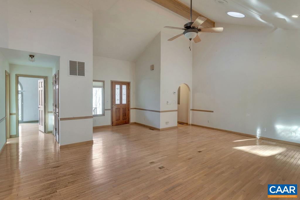 9 Out Of Bounds Road Palmyra, VA 22963 - Photo 6 of 37 a view of a livingroom with wooden floor and a ceiling fan
