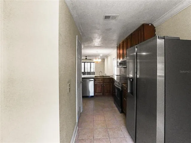 a kitchen with a refrigerator a sink and cabinets