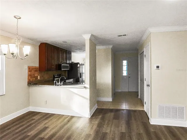 a view of a kitchen cabinets and wooden floor