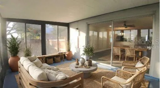 a living room with furniture and a floor to ceiling window