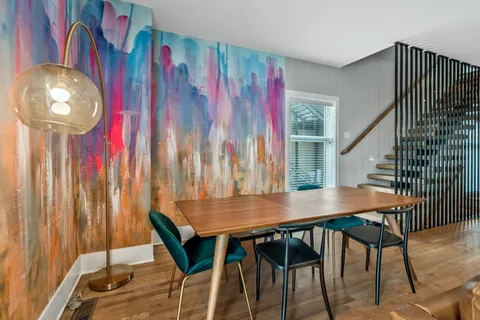 a view of a dining room with furniture and chandelier