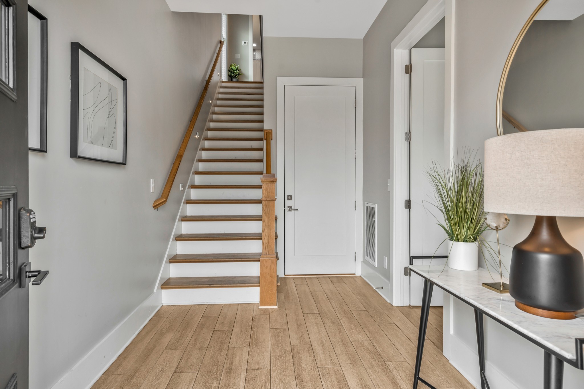 705 27th Avenue North Nashville, TN 37209 - Photo 2 of 41 a view of a hallway with wooden floor and stairs