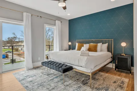 a bedroom with a bed and a window