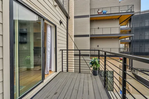 a view of balcony with wooden floor