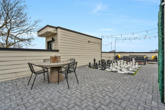 a backyard of a house with table and chairs