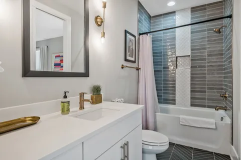a bathroom with a sink a toilet and shower curtain