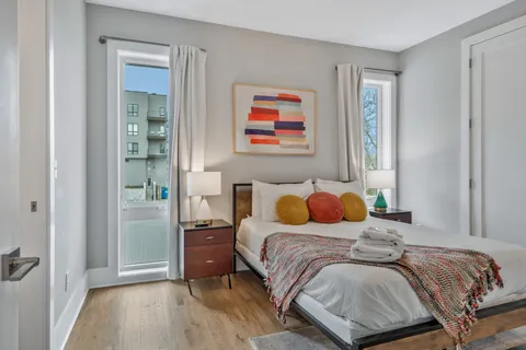 a bedroom with a bed and wooden floor