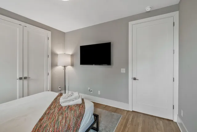 a bedroom with a bed and a flat screen tv