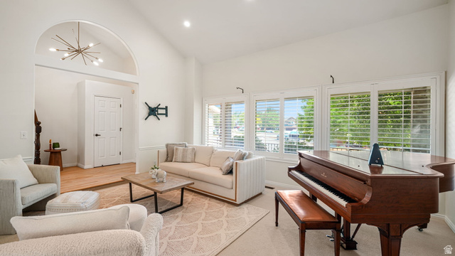 11128 South Barrett Pk Circle Sandy, UT 84092 - Photo 5 of 36 Spacious living area featuring high vaulted ceilings, multiple windows with plantation shutters, recessed lighting, and an arched entryway