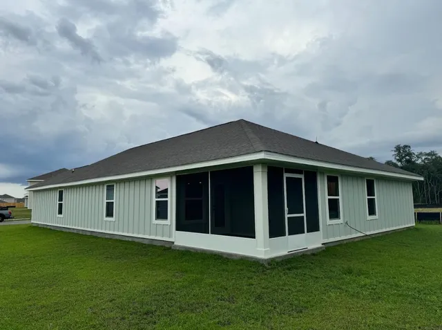 a big house with a big yard and large trees