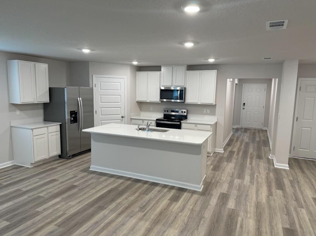537 Mary Lou Way Crestview, FL 32539 - Photo 7 of 10 a view of kitchen with microwave a stove and a refrigerator