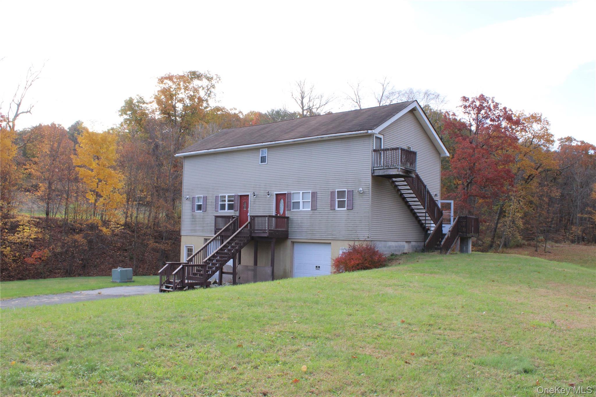 400 Round Lake Road Rhinebeck, NY 12572 - Photo 11 of 34 Back of house with stairway, a lawn, and an attached garage