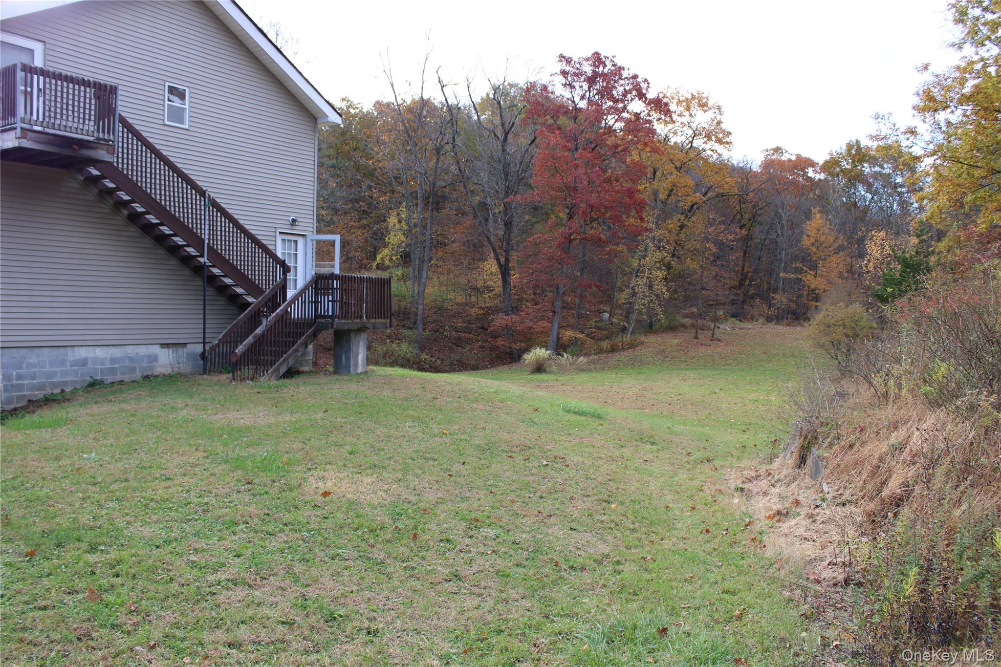 400 Round Lake Road Rhinebeck, NY 12572 - Photo 12 of 34 View of grassy yard with stairs and a wooden deck
