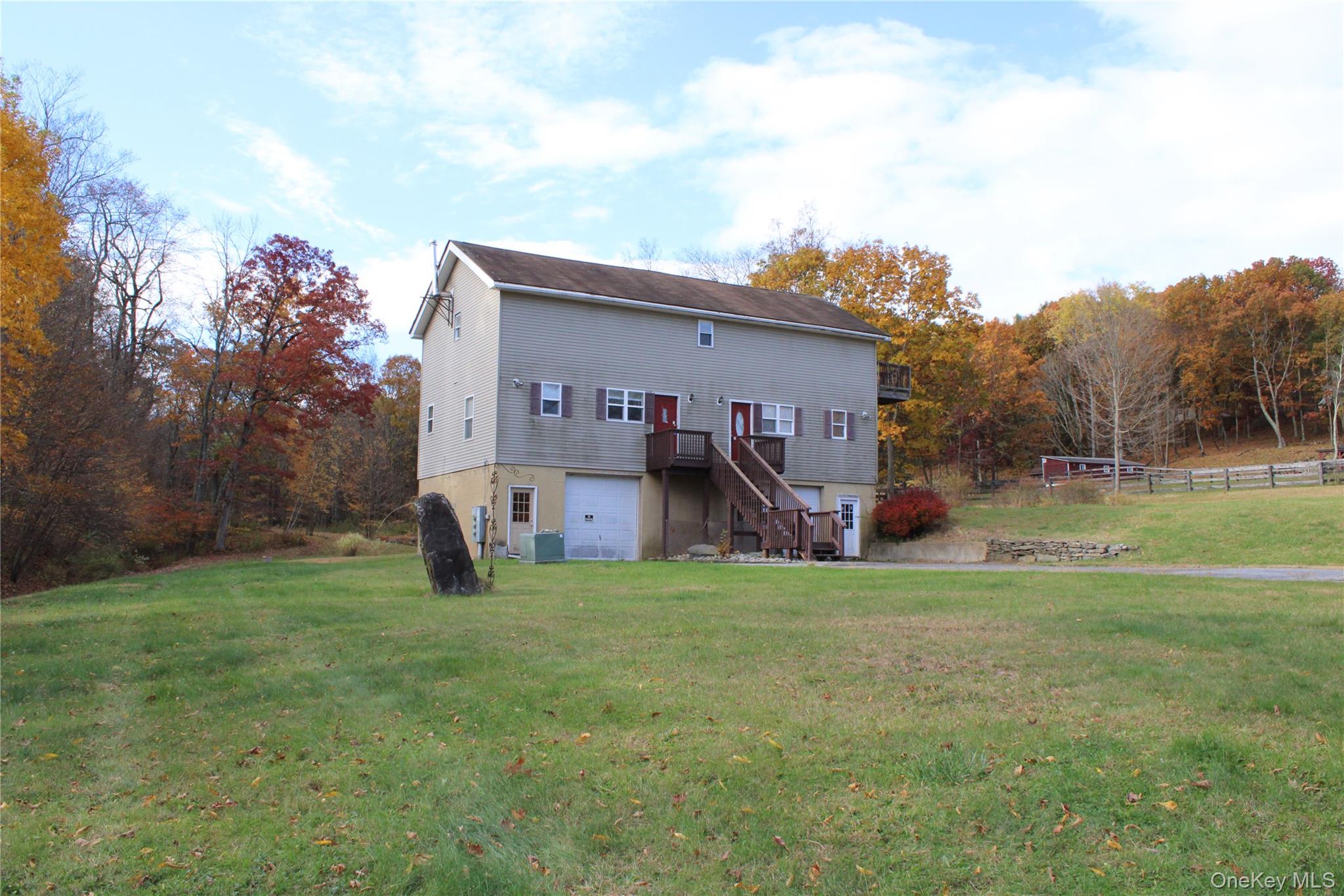 400 Round Lake Road Rhinebeck, NY 12572 - Photo 19 of 34 Back of property featuring a garage, a wooden deck, and stairway
