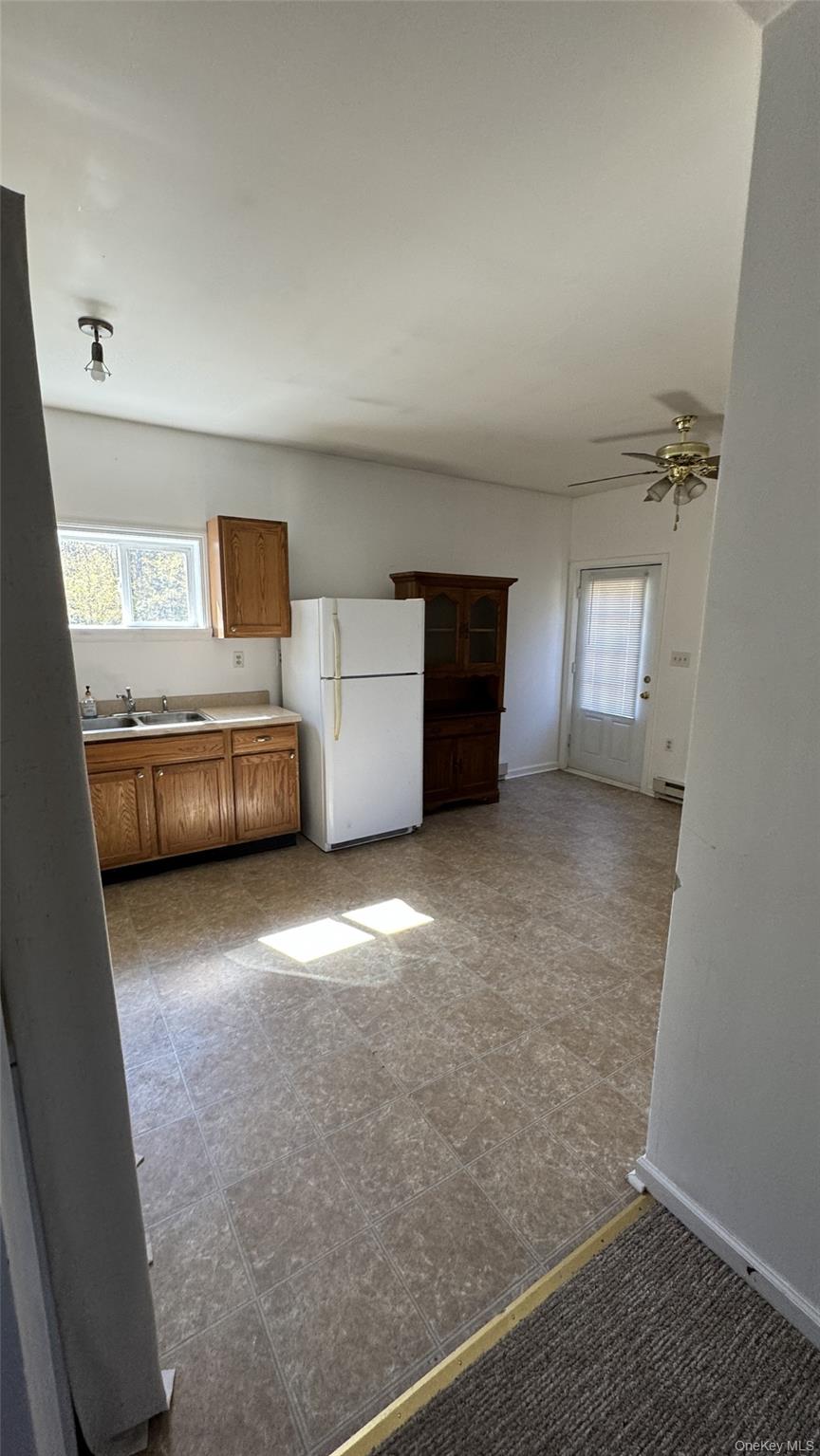 400 Round Lake Road Rhinebeck, NY 12572 - Photo 32 of 34 Kitchen with freestanding refrigerator, plenty of natural light, brown cabinets, and light countertops