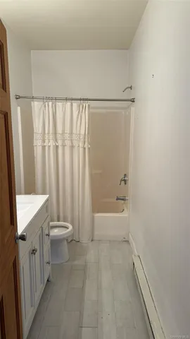 a view of a big room with closet and windows