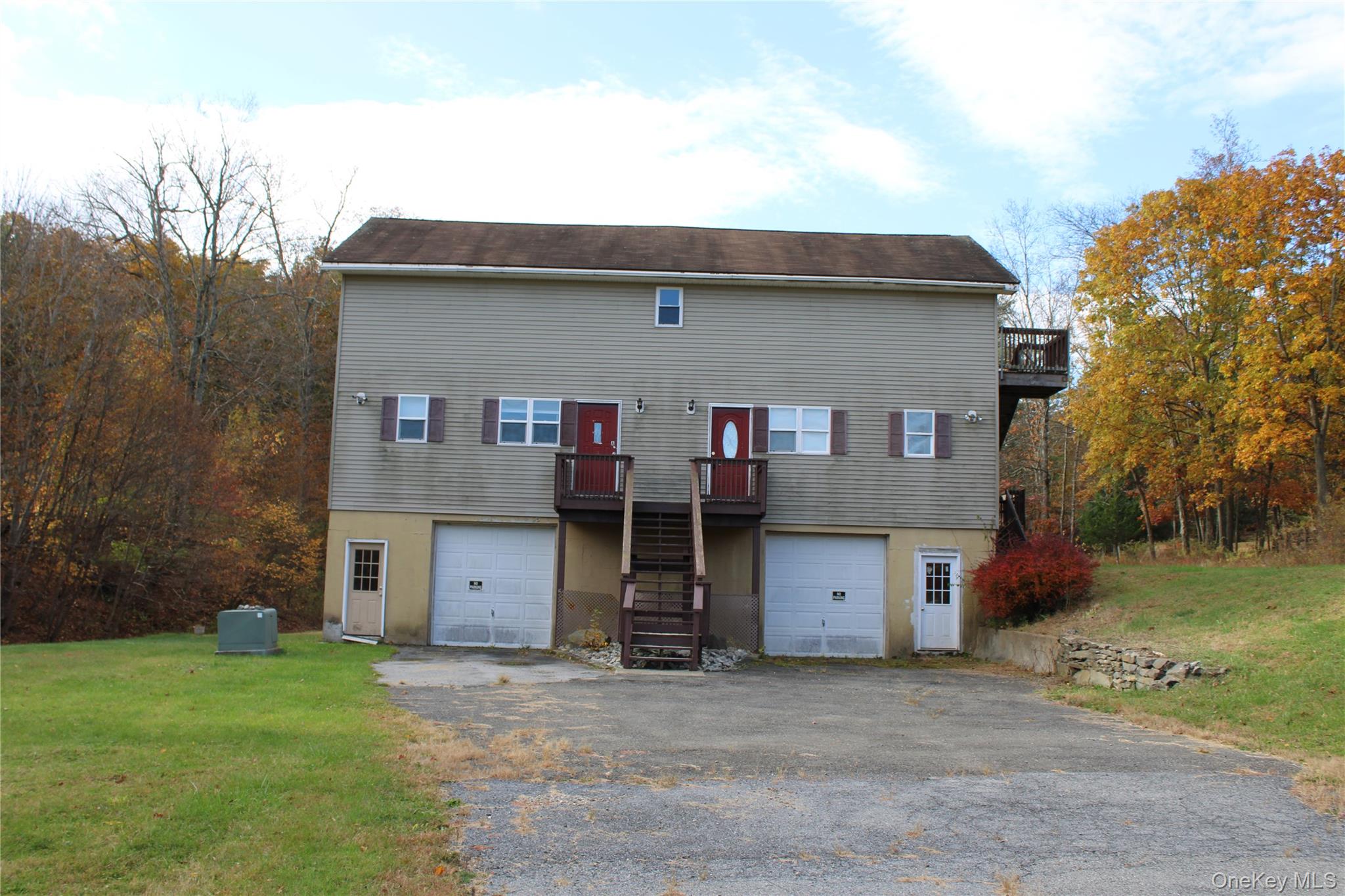 400 Round Lake Road Rhinebeck, NY 12572 - Photo 10 of 34 Rear view of house with a yard, an attached garage, and asphalt driveway