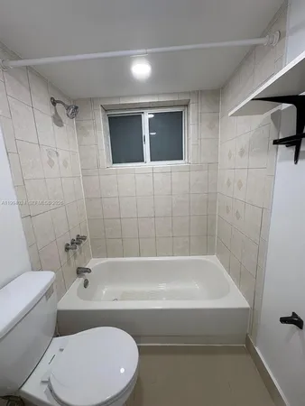 a bathroom with a toilet and a bathtub
