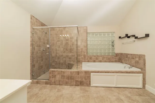 a bathroom with a bathtub and shower