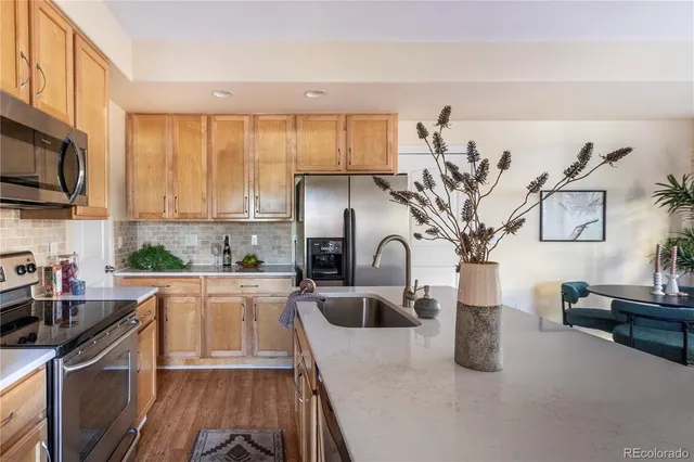 a kitchen with sink a stove and cabinets