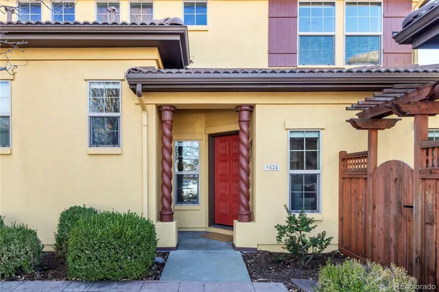 a front view of a building with potted plants