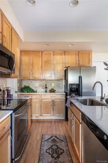 a kitchen with a sink stove top oven and microwave