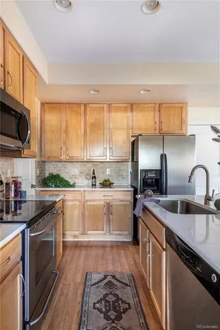 a kitchen with a sink stove top oven and microwave