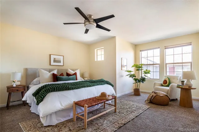 a bed room with a bed and a chairs