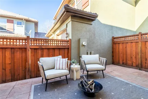 a building outdoor space with patio furniture and potted plants