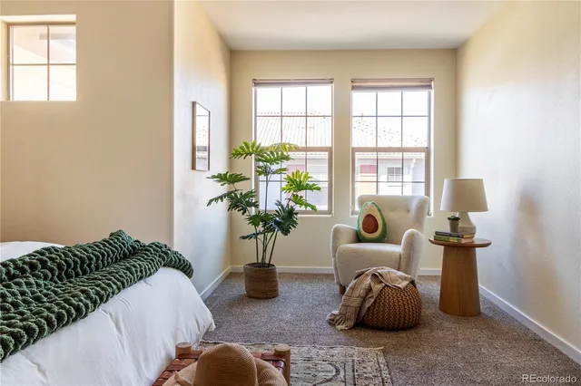a bedroom with furniture and a potted plant