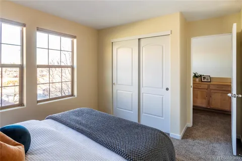 a room with a bed and a dresser