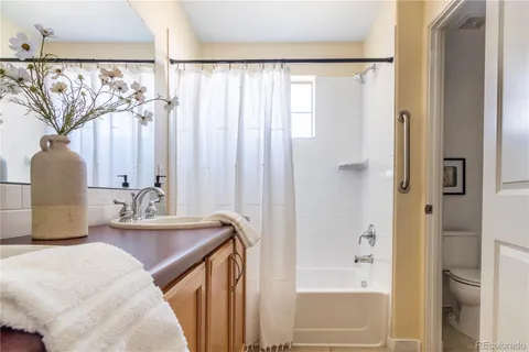 a bathroom with a sink toilet and a window