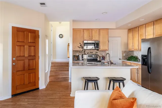 a kitchen with stainless steel appliances granite countertop a refrigerator and microwave