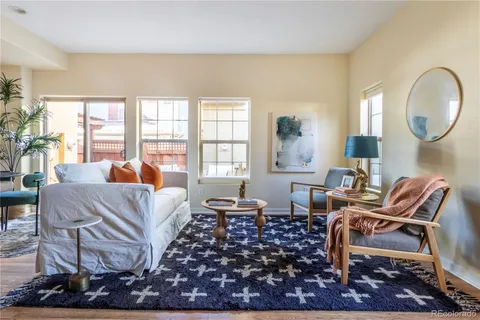 a living room with furniture a rug and a large window