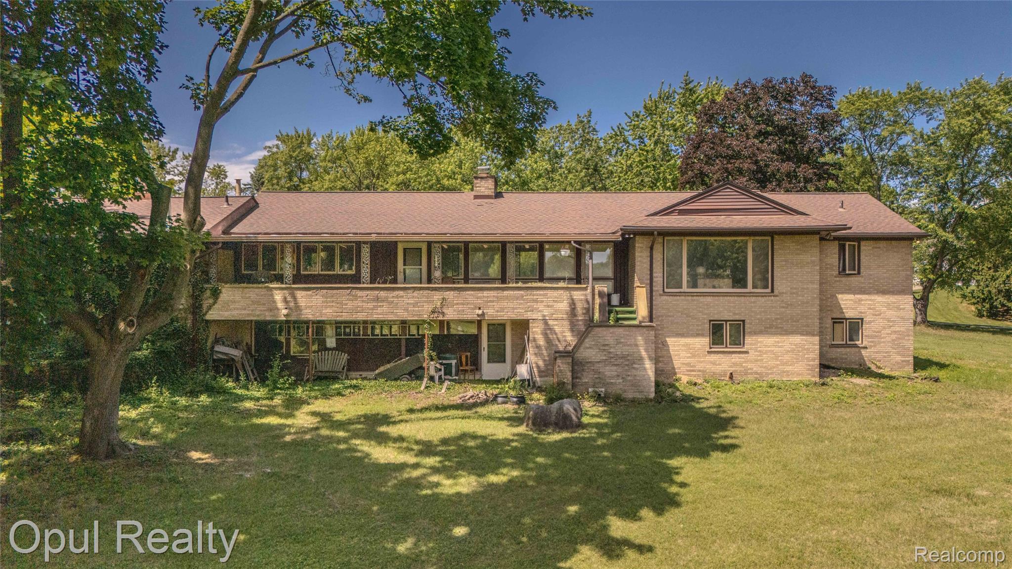 6455 Norham Road Bloomfield Hills, MI 48301 - Photo 83 of 93 Spacious brick exterior structure featuring a multi-level design and a prominent lower-level patio