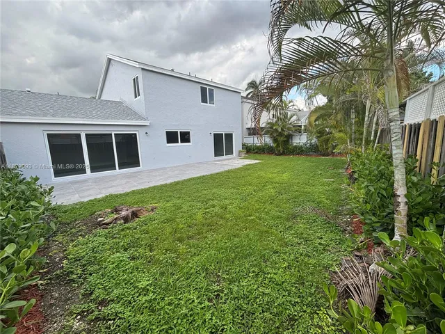 a view of house with yard