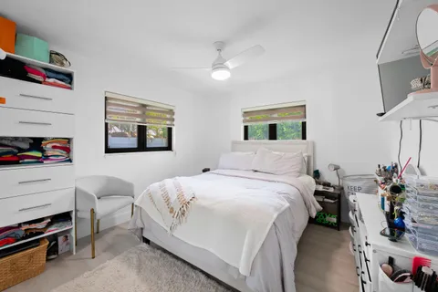 a bedroom with a bed and a large mirror