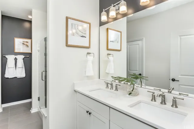 a bathroom with double sink and a mirror