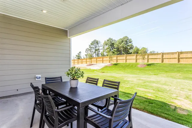 a view of an outdoor dining space with a table and chairs