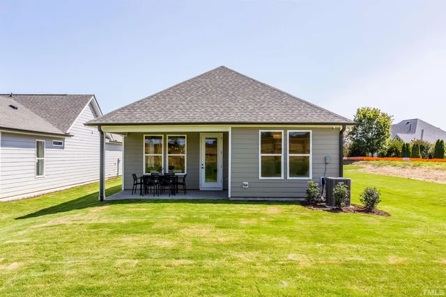 a house view with swimming pool in front of it