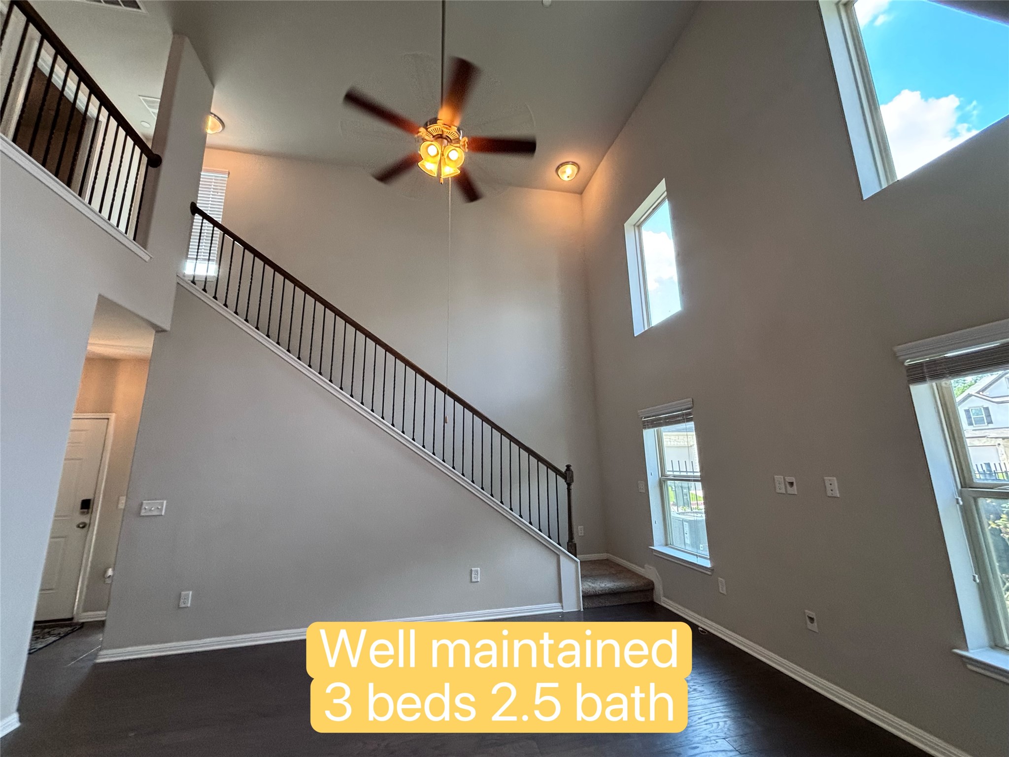 1612 Airedale Road Austin, TX 78748 - Photo 21 of 26 Dramatic two-story ceilings complement dark wood flooring, guiding the eye up a classic staircase to a landing above.
