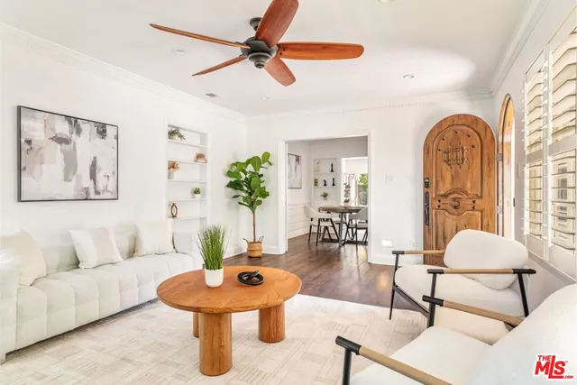 a living room with furniture and a potted plant