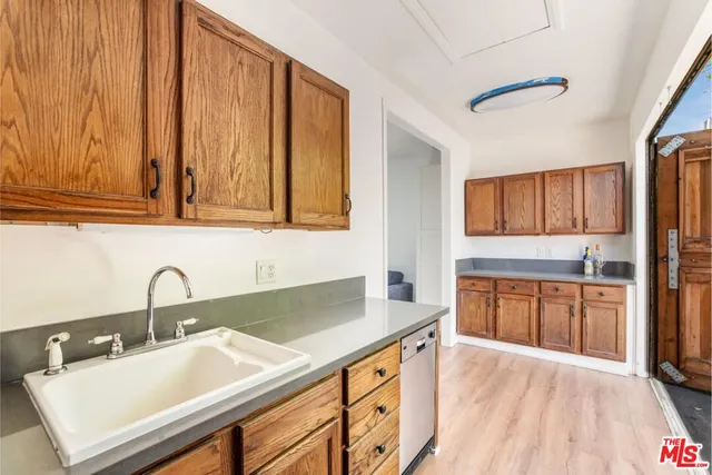 a kitchen with a sink cabinets and appliances