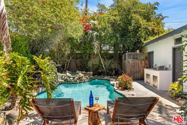 a view of a backyard with furniture and a garden