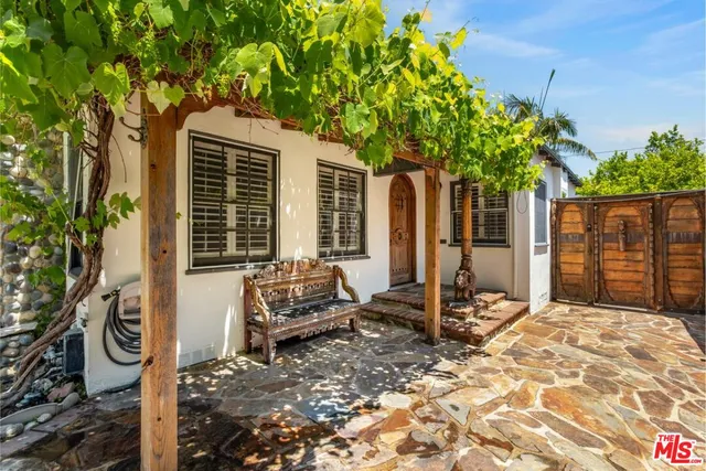 a house view with a sitting space and garden space