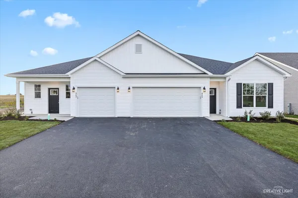 a view of a house with a yard and garage