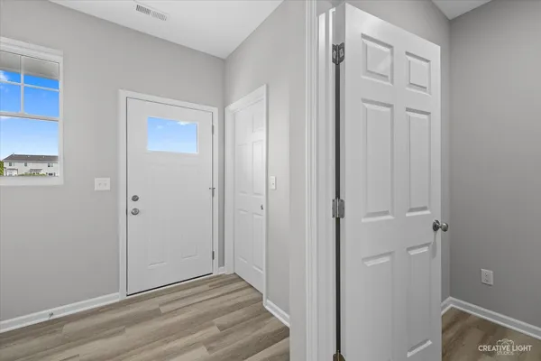 a view of a hallway with wooden floor